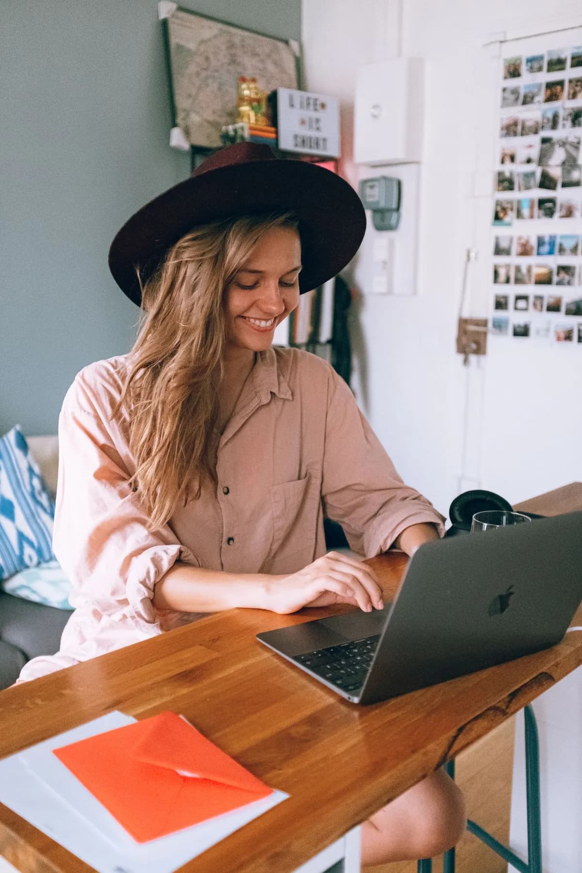 A smiling business owner managing bookings on her laptop